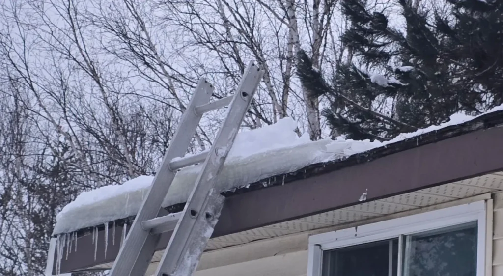 Snow and ice buildup along a residential roof edge